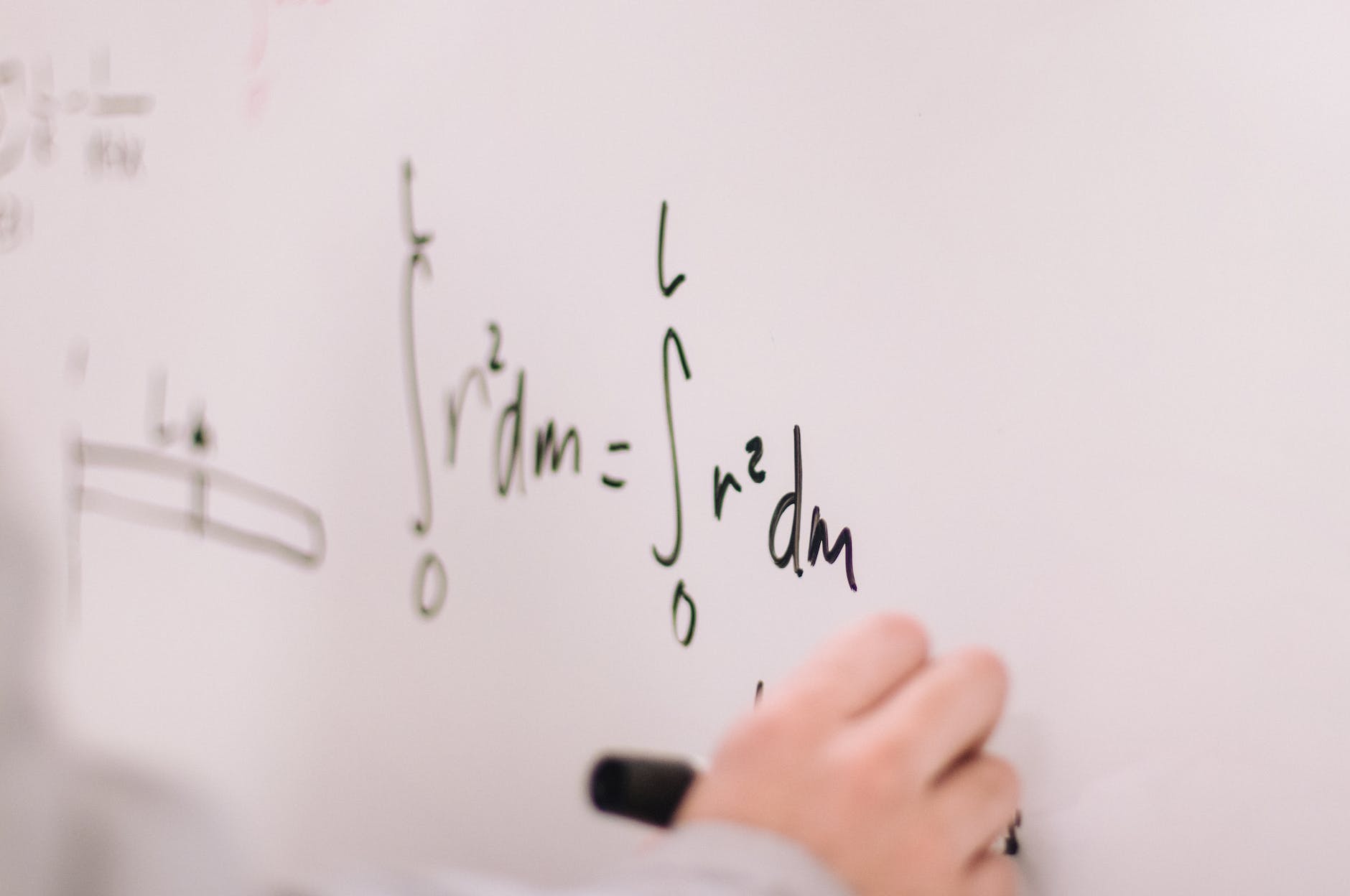 person writing on white board